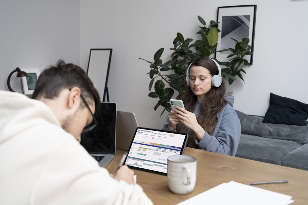 Woman using the Clarity Board™ digital planner on tablet to stay focused and organized with Google Sheets template.
